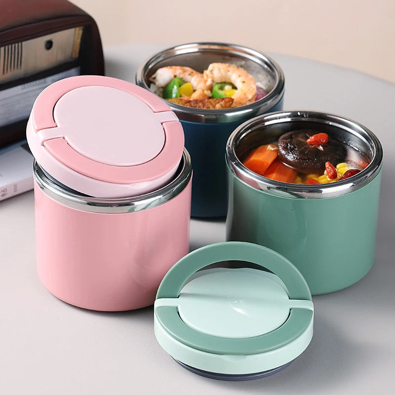 Three insulated lunch jars in pink, blue and green, filled with lunch