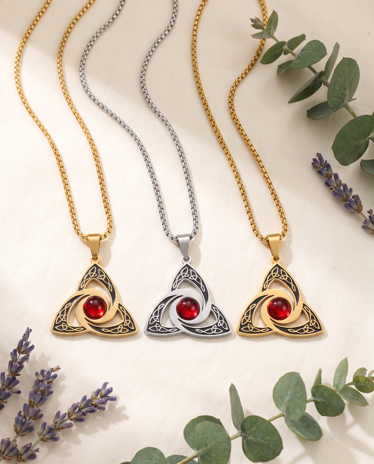 Three Celtic trinity knot necklaces in a row, gold, silver and gold